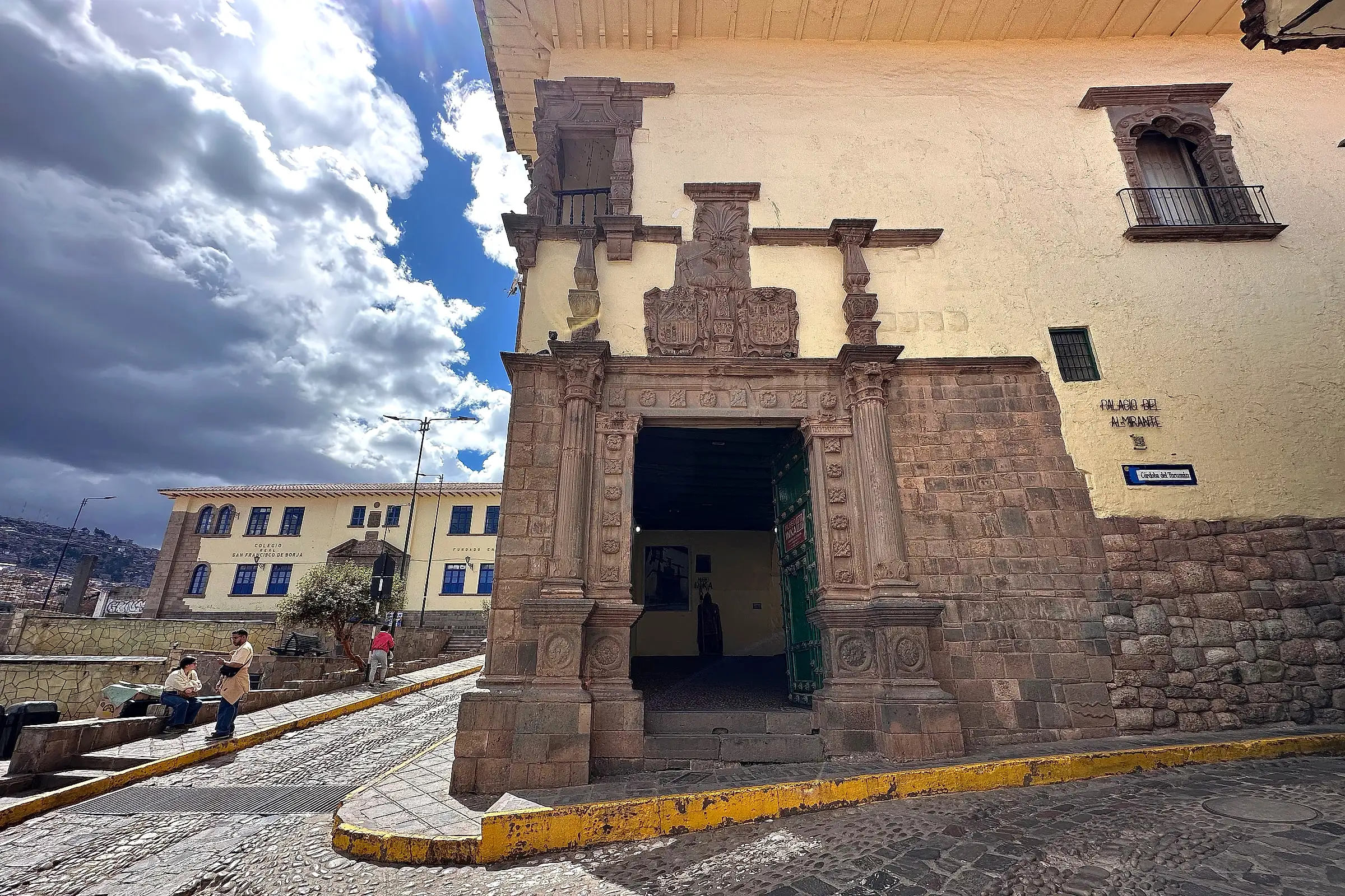A carved colonial doorway on a cobbled street in central Cusco, Peru