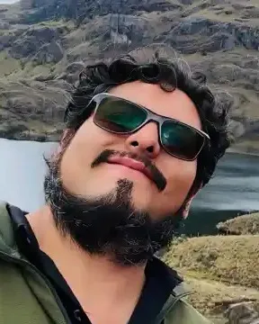Diego Plazarte in sunglasses above a mountain lagoon in the Ecuadorian Andes