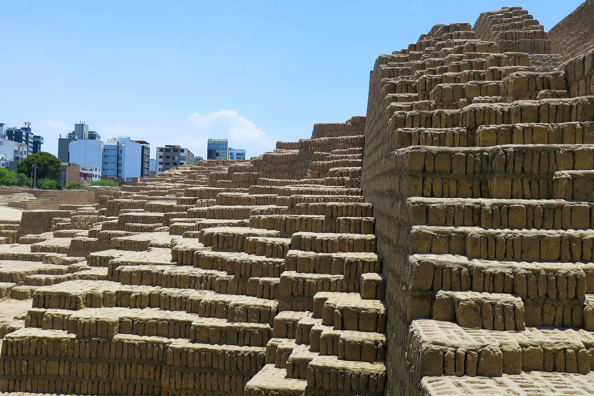 Adobe terraces of Huaca Pucllana rising beside the apartment towers of Miraflores in Lima