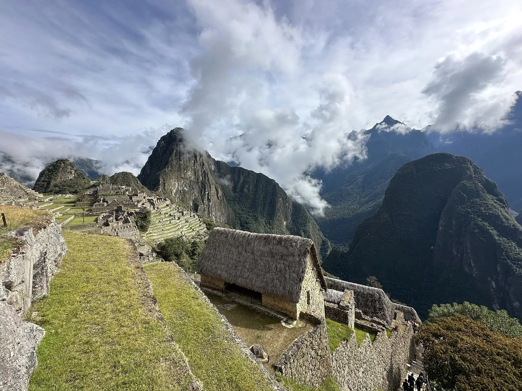 Huayna Picchu in cloud above the citadel terraces, the high point of these Machu Picchu tour packages
