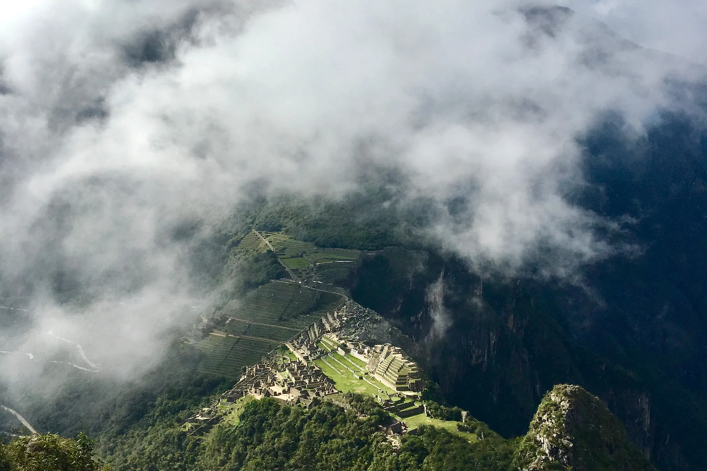 Clouds lifting off the Machu Picchu citadel seen from the summit of Huayna Picchu on a December morning