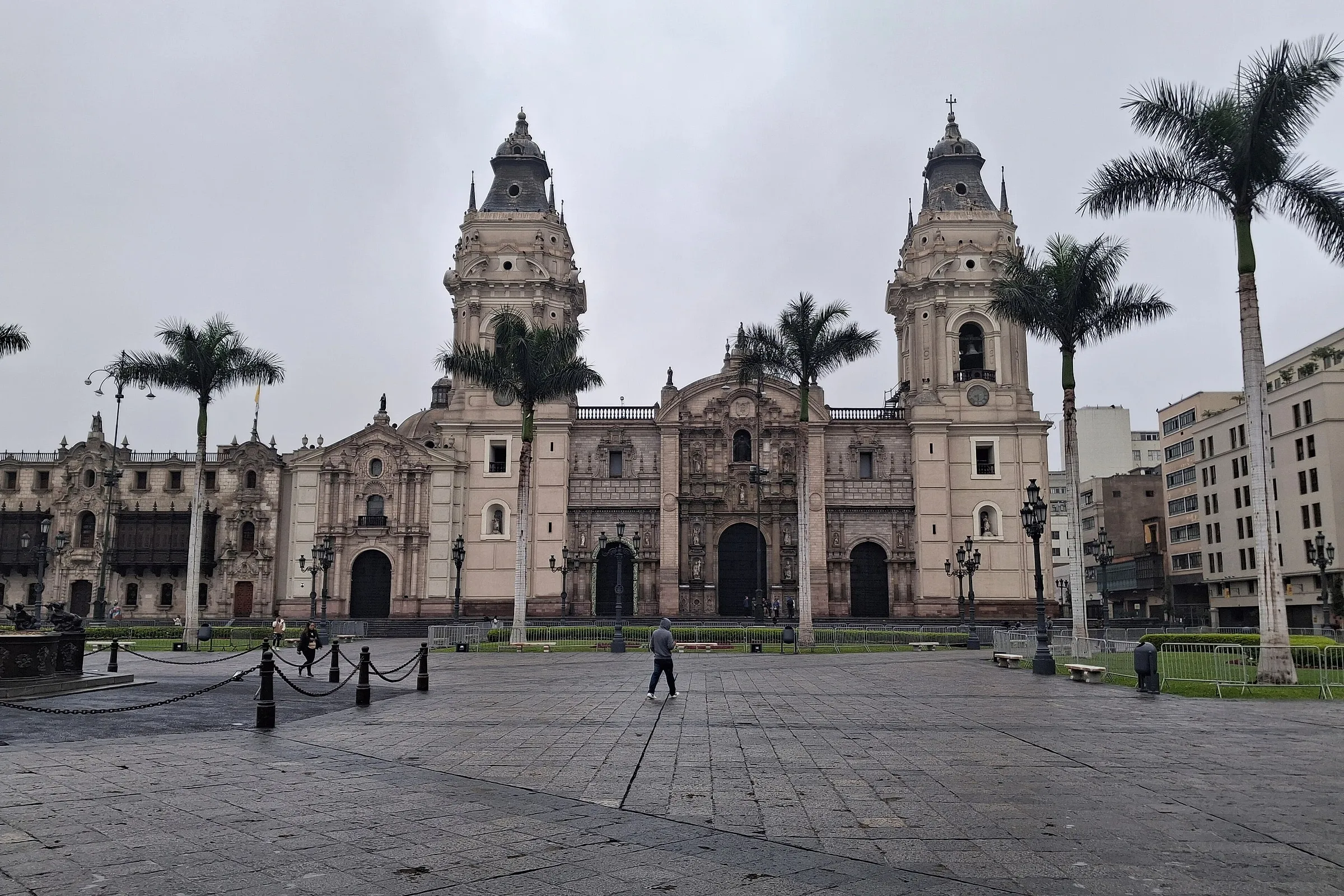 The towers of Lima Cathedral over the Plaza Mayor under a grey June sky