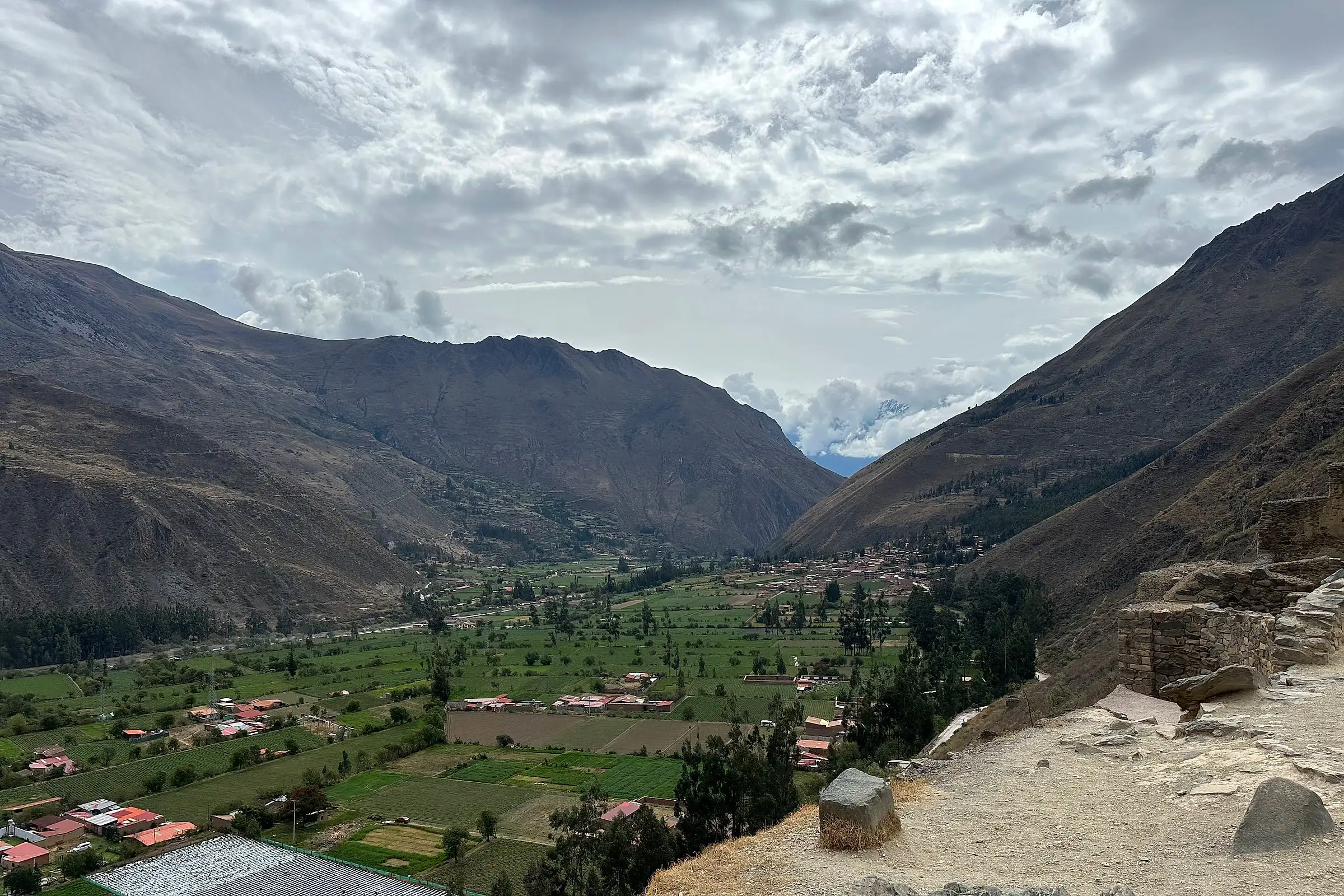 The Sacred Valley floor seen from the Inca terraces of Ollantaytambo, with the river and fields below