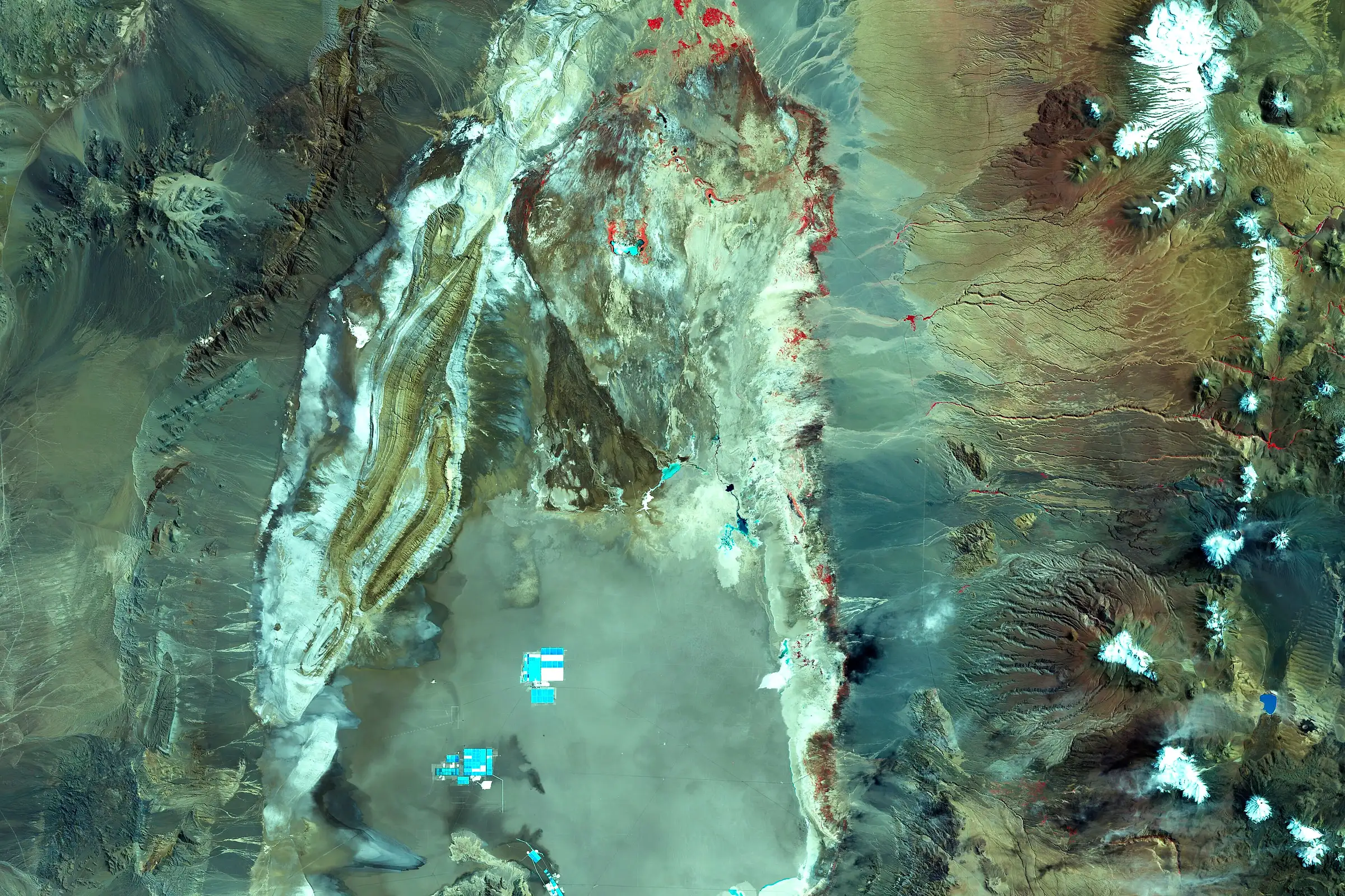 False-colour Landsat 7 satellite image of the Salar de Atacama salt flat, with snow-capped volcanoes to the east
