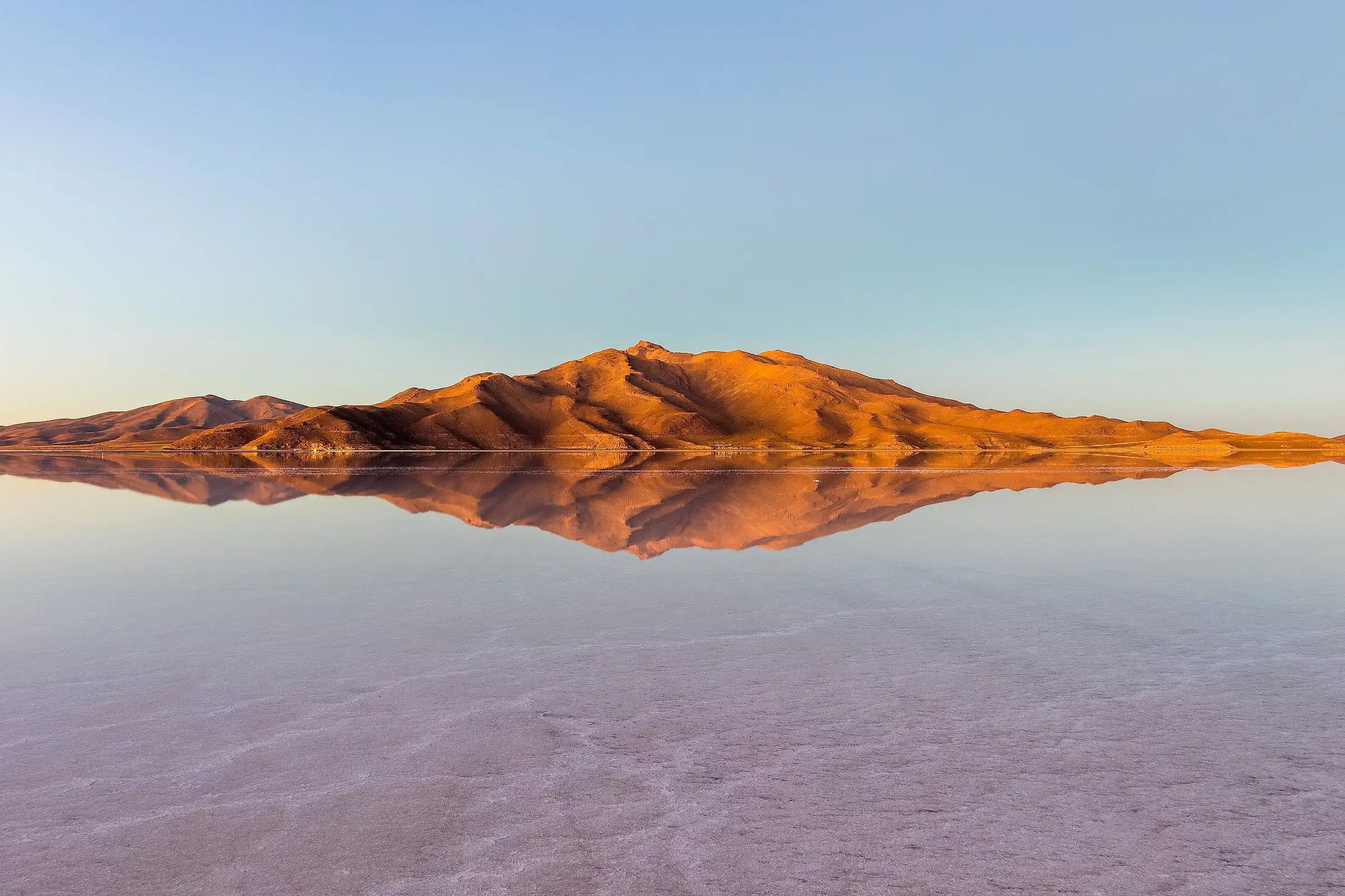 The Salar de Uyuni under shallow water, reflecting the sky to the horizon