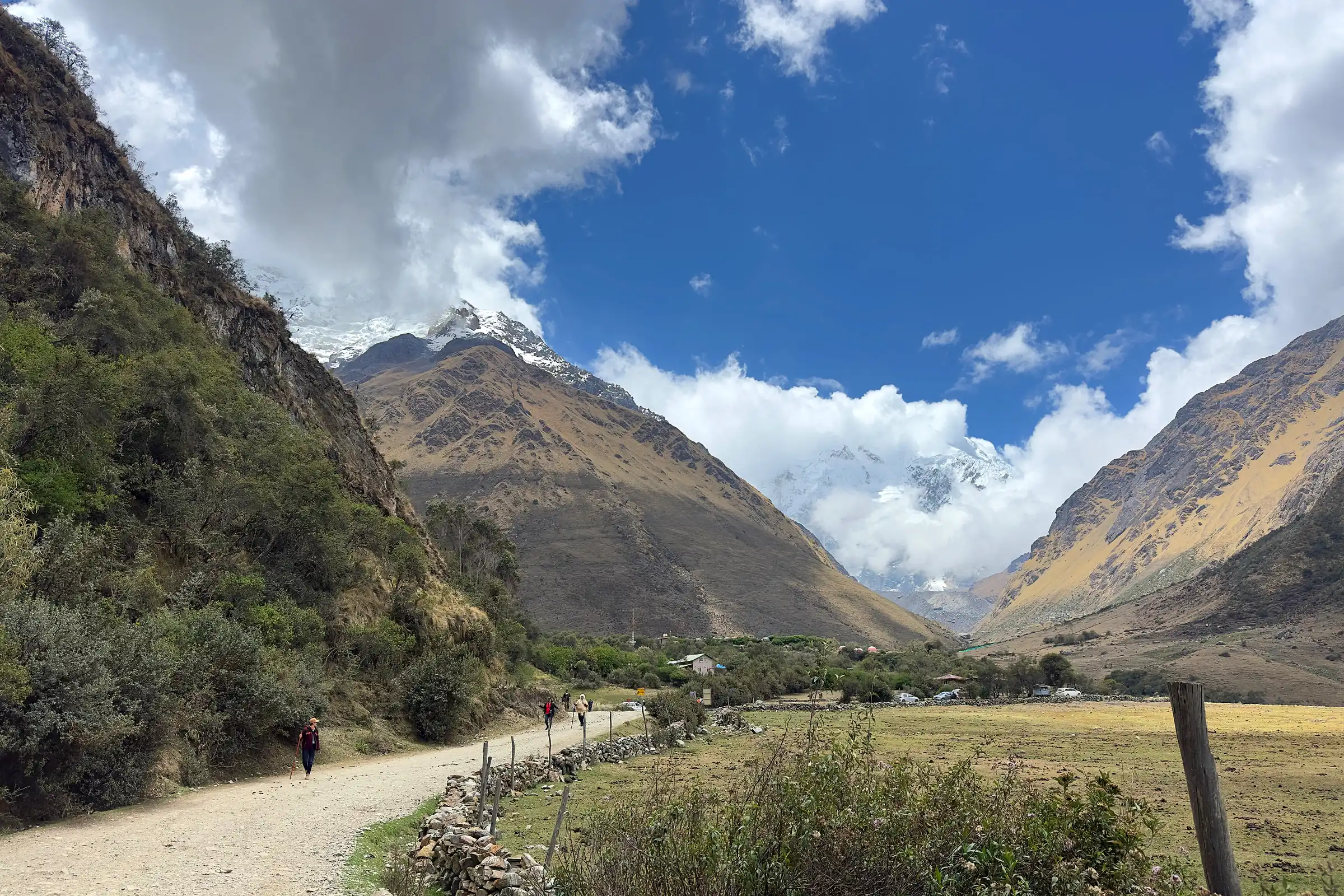 Soraypampa valley below snow-capped Salkantay under a blue sky, Cusco, Peru