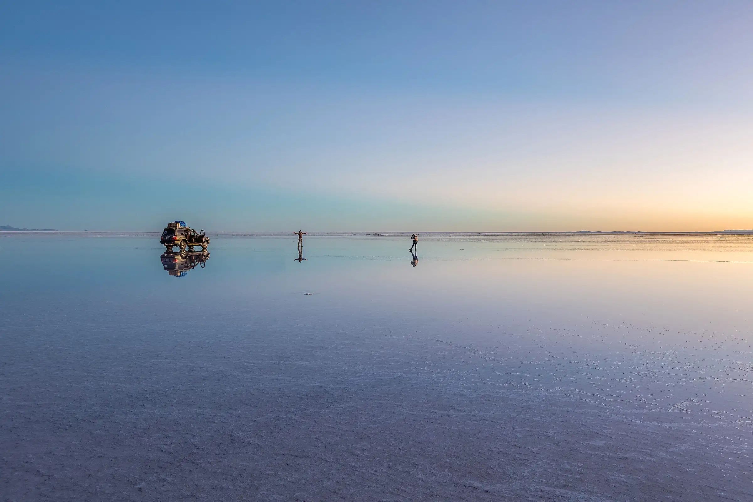 Sunrise reflected in the shallow water covering the Uyuni salt flat, Bolivia